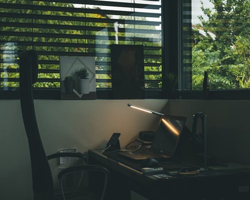 organized work desk with water and natural light