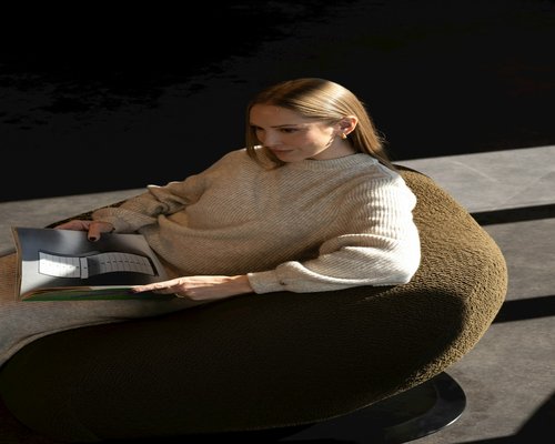 person reading a book in a comfortable room